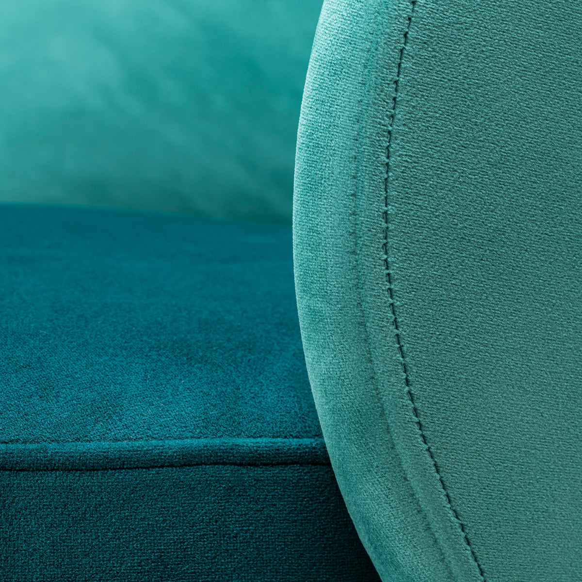 Close-up of teal fabric with stitching detail