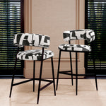 Eichholtz Bar Stool Folsom boasts black metal legs for a robust finish. This artisan-crafted bar stool elevates any living