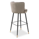 Eichholtz Bar Stool Grenada movement. Its metal frame with a swivel base ensures durability, making it a timeless addition