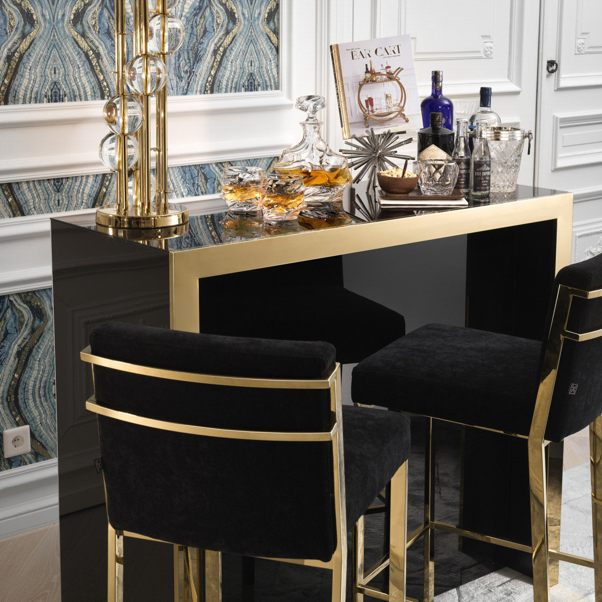 Eichholtz Bar Stool Scott the luxury Scott Barstool. Its gold finished frame with footrest adds glamour and sophistication to