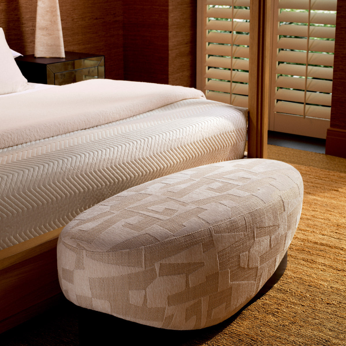 Eichholtz Bench Raymond in a textured Brooklyn sand fabric, this bench stands out with its sleek black veneer