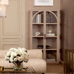 Eichholtz Cabinet San Bernardino of modern elegance and timeless design. Its arch silhouette and clear glass panels invite a