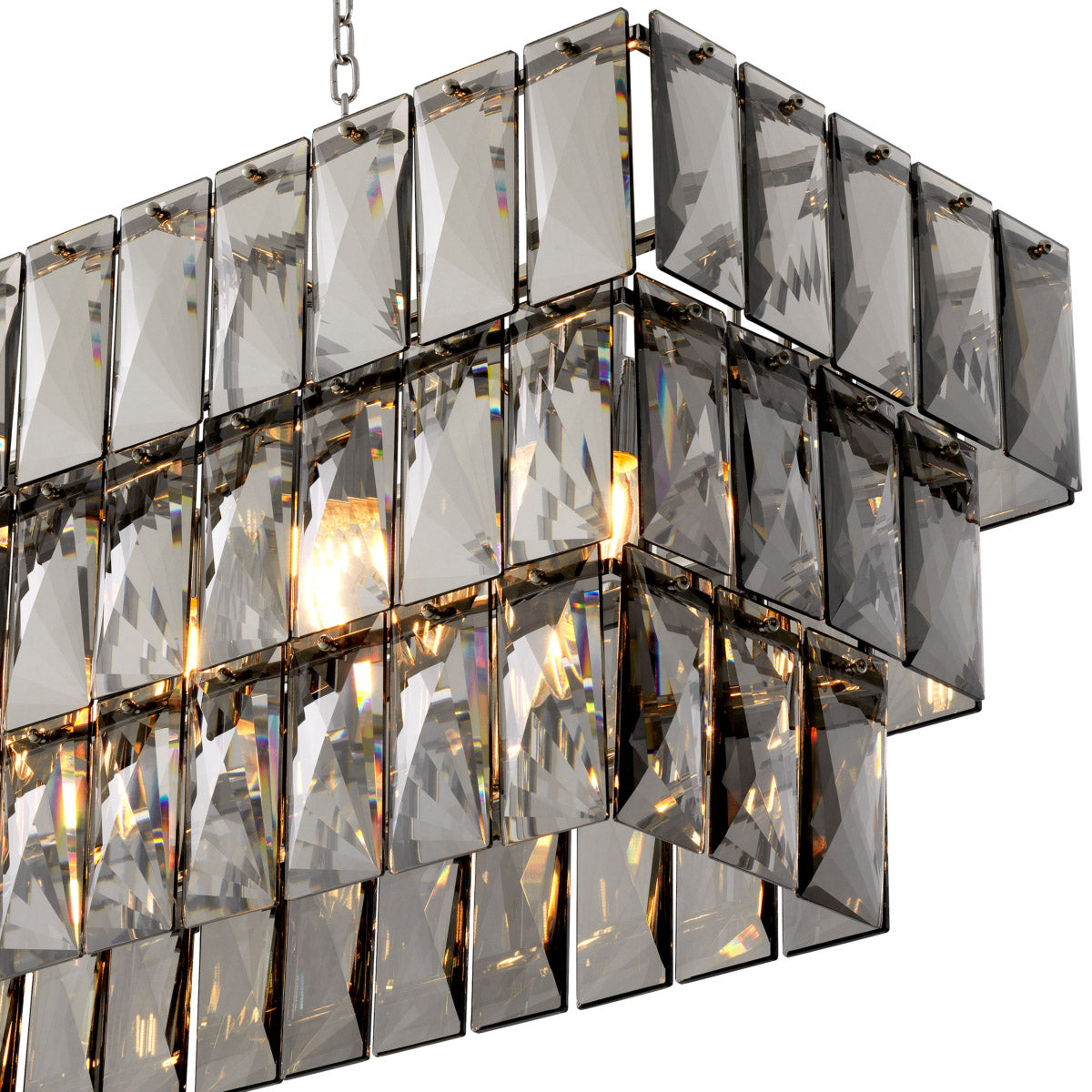 Eichholtz Chandelier Amazone rectangular features a 3-layered nickel finish frame filled with rectangular smoke crystals that capture and...