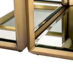 Eichholtz Coffee Table Callum set of 4 Table. Its brushed brass frame with bevelled rims surrounds the tabletops of smoke glass and