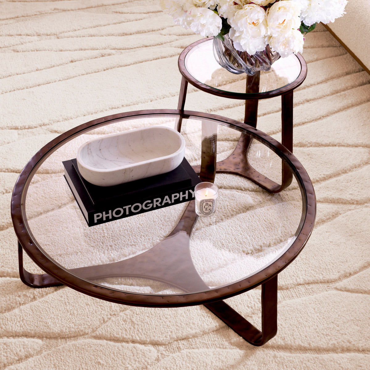 Eichholtz Coffee Table Cambronne hammered cast aluminum base in a sumptuous bronze finish, coupled with a sleek clear glass
