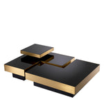 Eichholtz Coffee Table Nio set of 4 and adorned with brushed brass rims, each piece has a surface of black glass. You