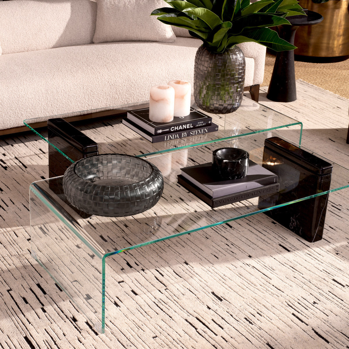 Eichholtz Coffee Table Stonecrest table features a base made of black marble topped with clear glass, combining sleek modernity