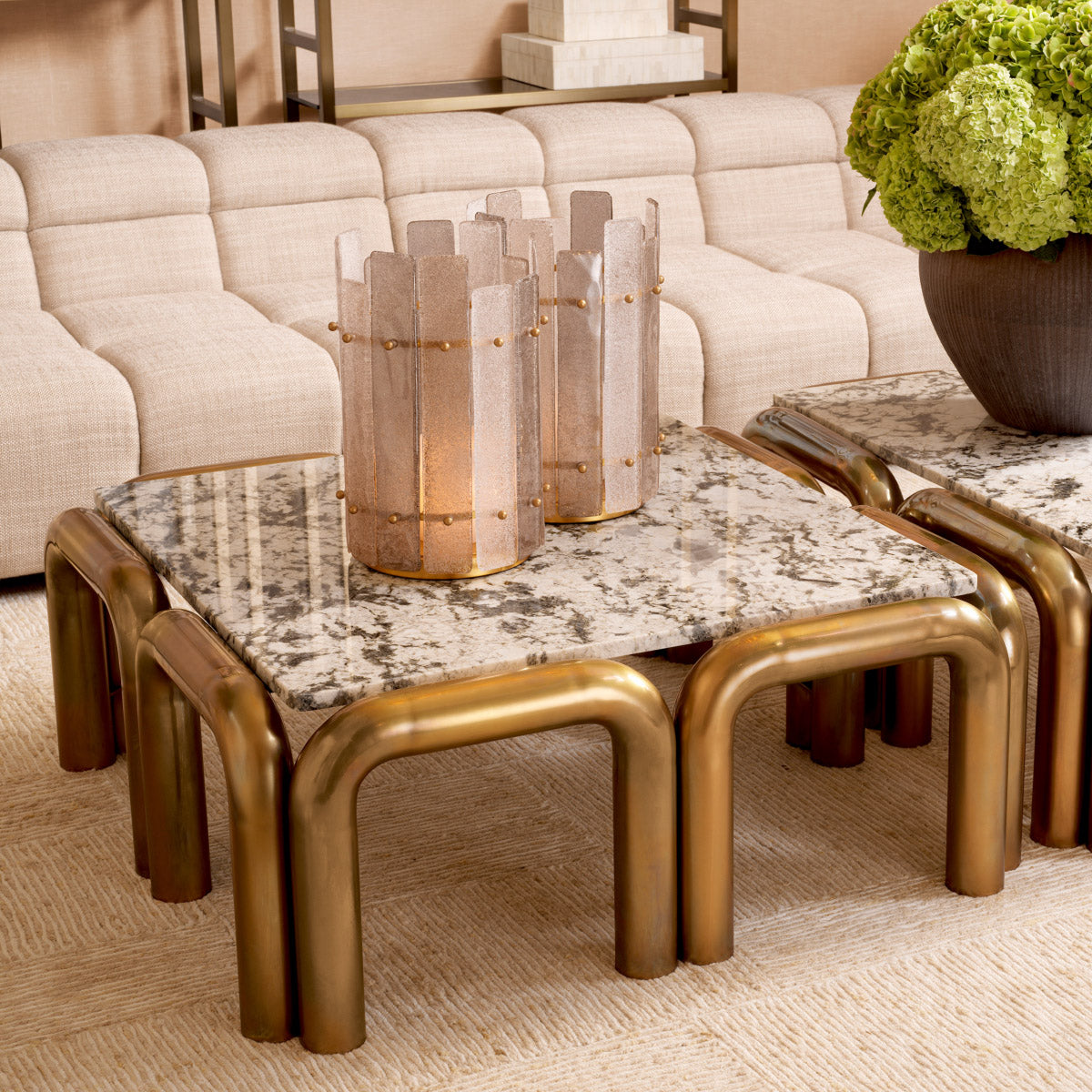 Eichholtz Coffee Table Sunwood showcases unique veining, ensuring every piece is distinct. The bold legs in a vintage brass