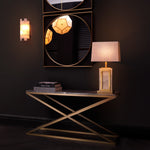 Eichholtz Console Table Criss Cross materials. With its intersecting brushed brass frame and elegant grey marble top, this console table