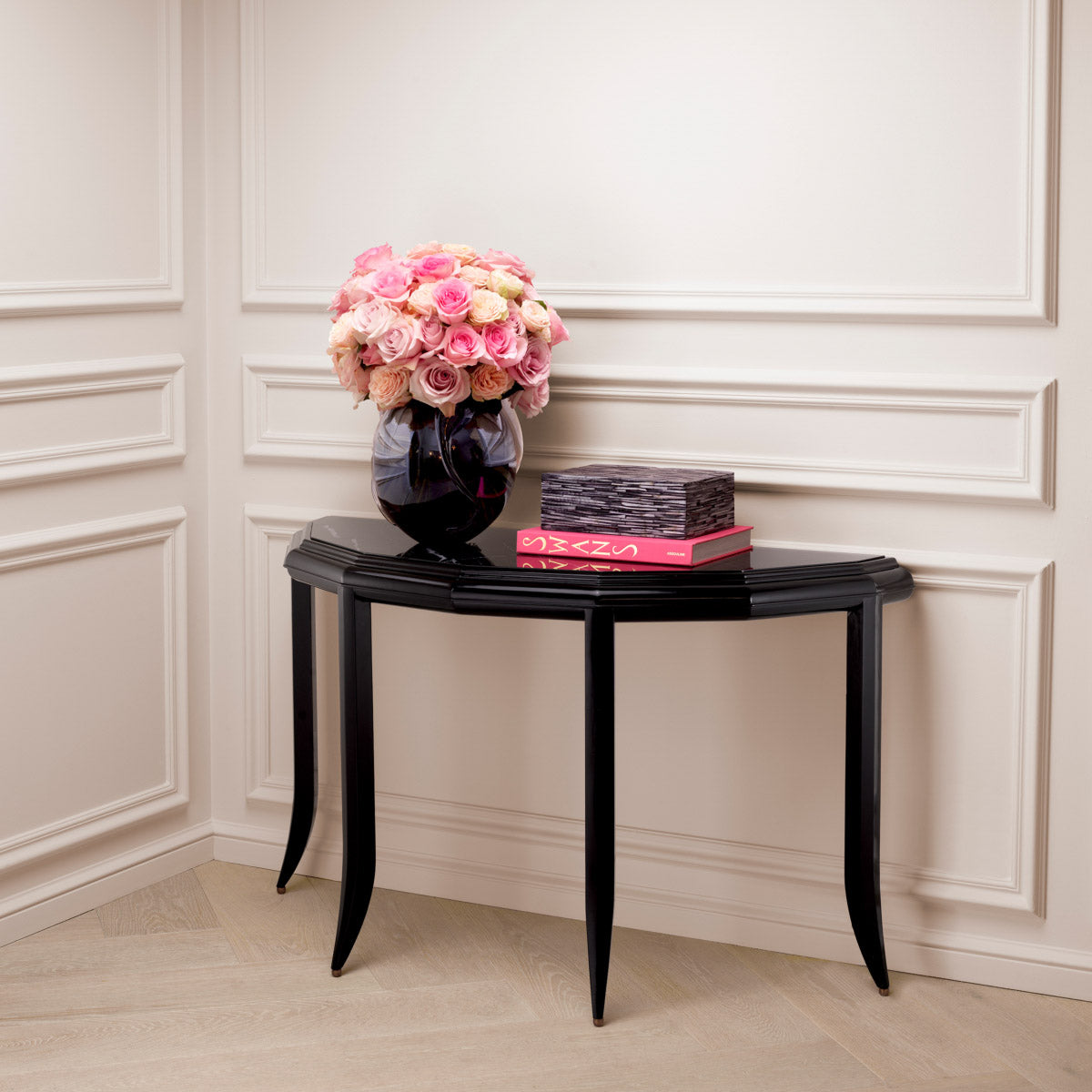 Eichholtz Console Table Javier design. Its waxed black finish and black marble top exude timeless elegance, showcasing unique colour