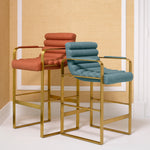 Eichholtz Counter Stool Olsen Counter Stool in Scalea orange. Celebrate artisan craftsmanship with its plush metal body draped in