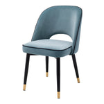 Eichholtz Dining Chair Cliff black tapered legs with gold caps, the solid frame holds an armless back that is