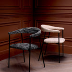 Eichholtz Dining Chair Julio set of 2 its contemporary black legs and Bouclé sonata black fabric, showcases unique variations in colour and