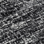 Eichholtz Dining Chair Julio set of 2 black legs and Bouclé sonata black fabric, showcases unique variations in colour and texture. The