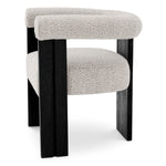 Eichholtz Dining Chair Percy armrests. Upholstered in a Bouclé grey fabric, it allows your guests to enjoy seating for