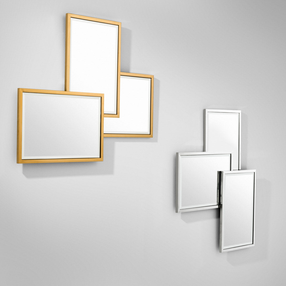 Eichholtz Mirror Sensation asymmetric shapes and bevelled edge mirror glass set in a stainless steel frame. Mirror Sensation