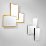 Eichholtz Mirror Sensation asymmetric shapes and bevelled edge mirror glass set in a metal frame in gold finish.