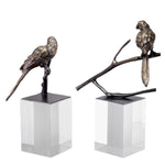 Eichholtz Object Morgana set of 2 figurine is provided with a bronze highlight finish and sits on an acrylic cubicle base.