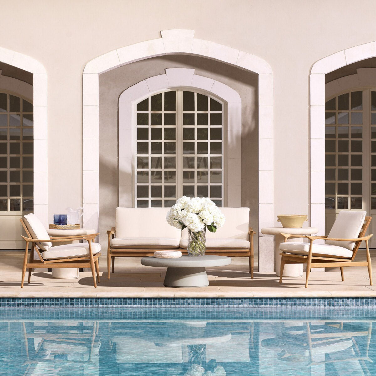 Eichholtz Outdoor Coffee Table Cleon indoor space. Crafted with glass fibre reinforced concrete, the table boasts a matte dry look