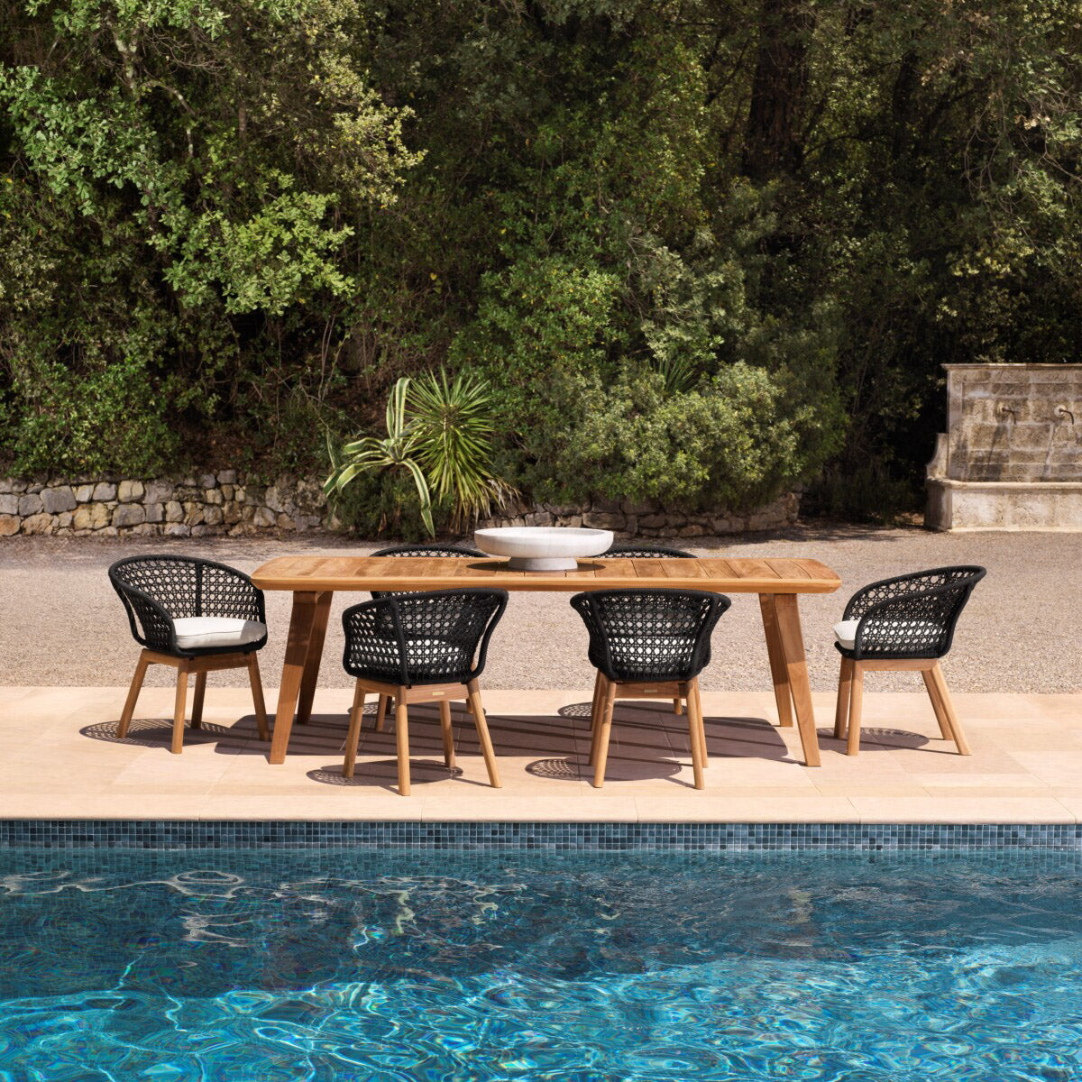 Eichholtz Outdoor Dining Chair Trinity teak wood. Featuring a stylish black rope woven pattern, the Trinity offers both comfort and