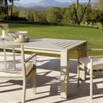 Eichholtz Outdoor Dining Table Vistamar for long-term outdoor use, this luxurious sand finish dining table with decorative slits will add