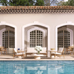 Eichholtz Outdoor Sofa Manzo wood. Featuring a luxurious off-white Flores outdoor fabric cushion set, this sofa is perfect for