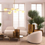 Eichholtz Planter Jasper round high showcases a vintage brass finish, imbuing it with a sophisticated antiquity ideal for any luxury