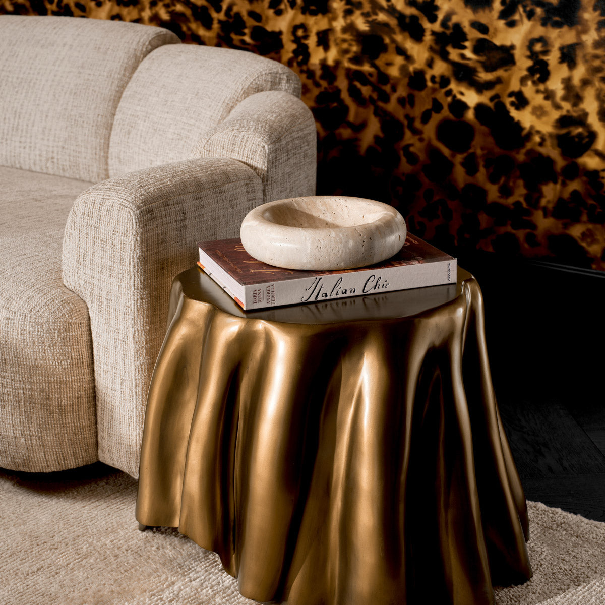 Eichholtz Side Table Chabot brass finish exudes a timeless elegance, while the unique shape of the tablecloth adds a