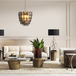 Eichholtz Side Table Emmeline rests atop a gracefully hammered vintage brass base, offering an elegant fusion of timeless materials.