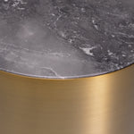 Eichholtz Side Table Porter round base and a grey marble top. The warm look of the brass counterpoints the cool