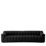 Eichholtz Sofa Kelly L black bouclé upholstery. Featuring a gently curved design and deep channel stitching, this generous sofa
