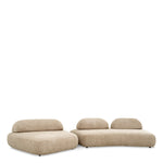 Eichholtz Sofa Residenza a side table between the two sections to create a convenient space for decor items.