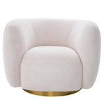 Eichholtz Swivel Chair Roxy Sitting on a round brushed brass swivel base, this accent chair features a sheltering arc