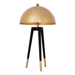 Eichholtz Table Lamp Coyote a dome-shaped lampshade in gold finish and black tapered legs with gold finish brass caps,