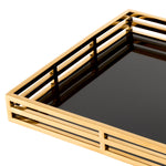 Eichholtz Tray Giacomo table arrangements. Featuring a black glass bottom shelf and open-sided gold finish surround, this rectangular