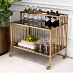 Eichholtz Trolley Rutherford brass finish adds a touch of antique allure, while the smoked glass creates a hint