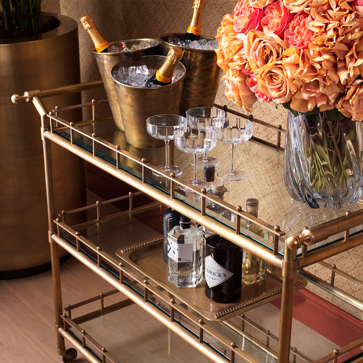 Eichholtz Trolley Scarlett L brass. Its clear glass shelves offer a sleek showcase for your finest essentials, blending opulence