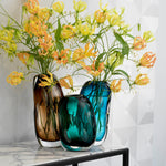 Eichholtz Vase Sianni M flowers. The extraordinary shape with enclosed air bubbles makes this blue glass vase a real