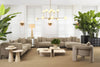 A curated Eichholtz living room — neutral tones with globe chandelier, cream sectional, and tropical plants