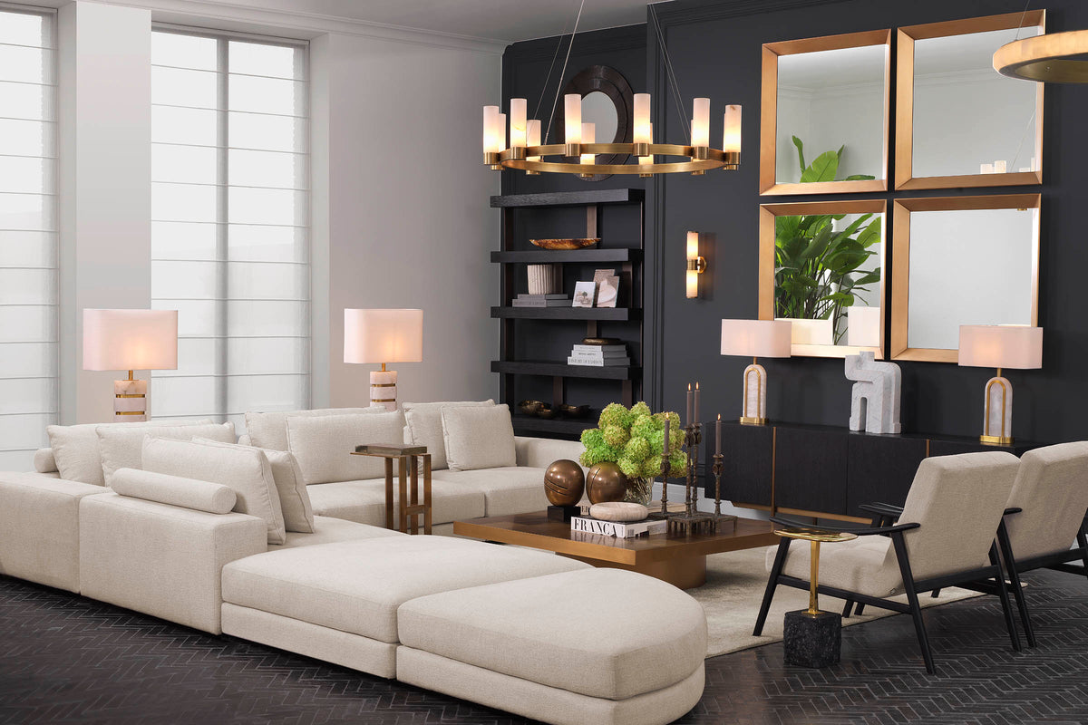 A curated Eichholtz living-room interior — layered neutral tones, warm brass accents, and refined upholstered seating.