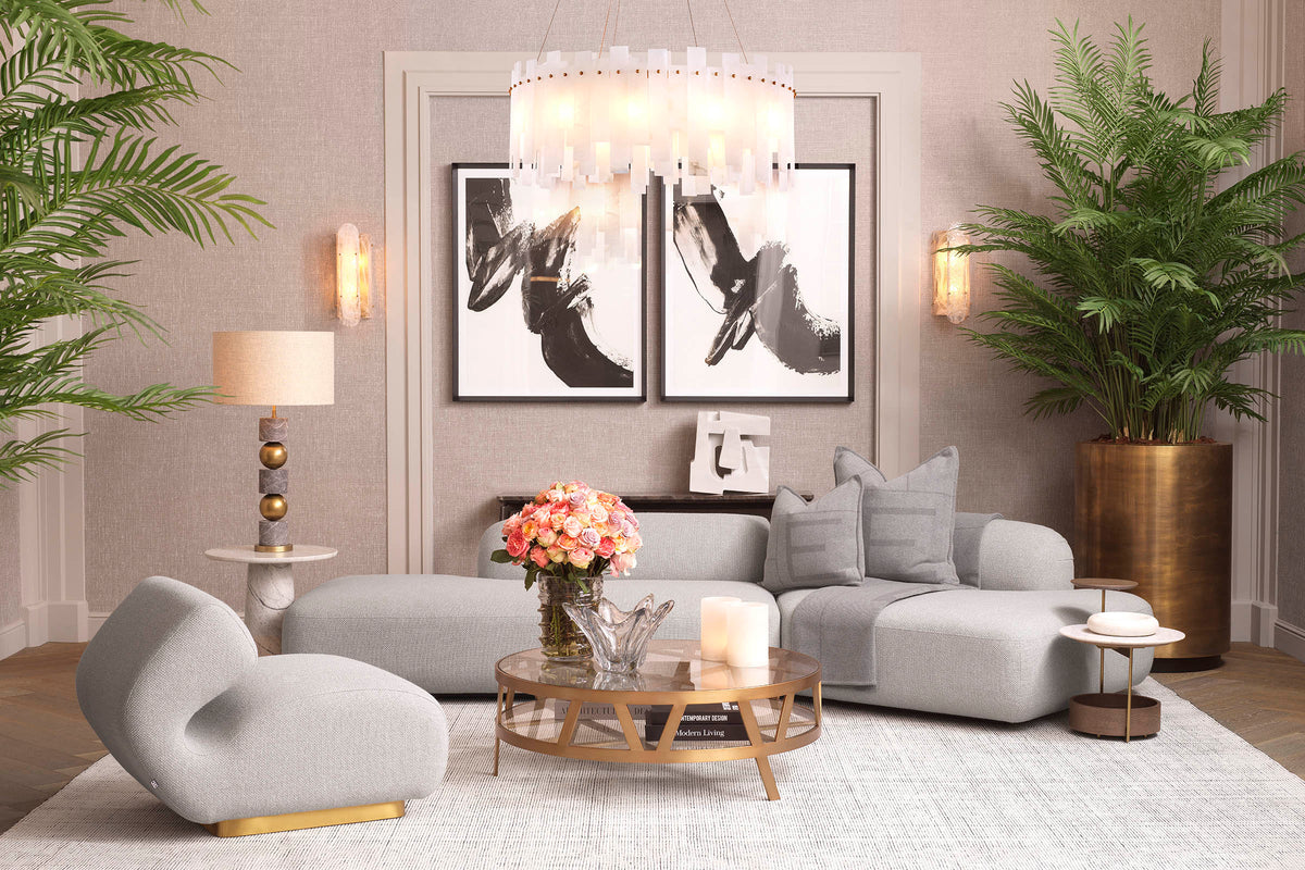A curated Eichholtz living-room editorial — warm neutrals, sculptural brass elements, and layered seating in a refined residential setting.