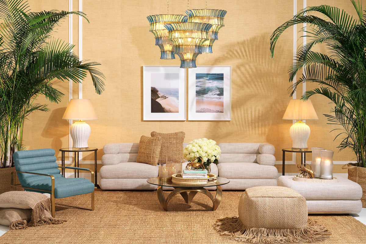 A curated Eichholtz living-room vignette — cream sofa, crystal chandelier, and warm layered tones, from the Eichholtz Las Vegas showroom collection.