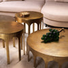Eichholtz Side Table Gardini — antique brass cast metal side tables in three sizes styled alongside a cream boucle sofa on a warm rug