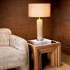 A luxury living room vignette featuring the Eichholtz Side Table Metropolitan — open-grain oak veneer base with antiqued mirror glass top, from The Met × Eichholtz collection