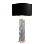Table lamp with black shade and marble base on a white background