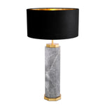 Table lamp with black shade and marble base on a white background