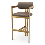 Eichholtz Bar Stool Donato brushed brass finish seymore truffle Elevate your space with the sophisticated charm of the Donato bar stool. A true statement piece, thi