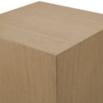 Beige cube with a textured surface on a white background