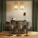 Lifestyle angle of Bar Stool Carleton with back with refined Brushed Brass, Camari Green, Swivel Base tones (Image 8)