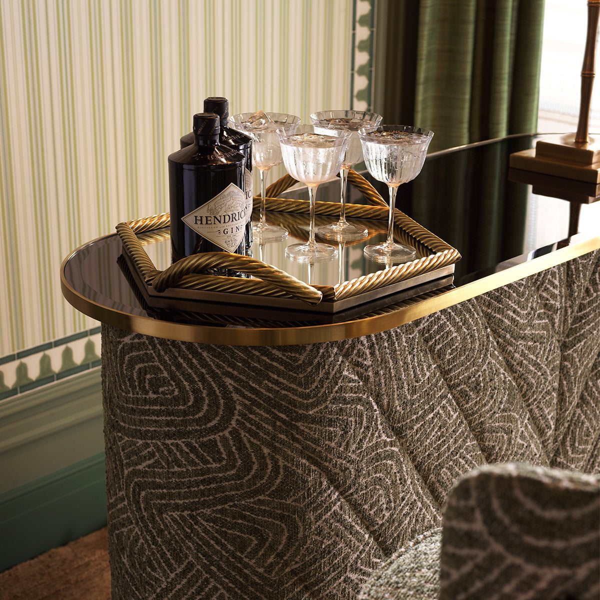 Close-up of Bar Matthew highlighting Brass, Glass, Viscose, Linen, Polyester, Acrylic and Brushed Brass, Black Glass, Camari Green (Image 10)